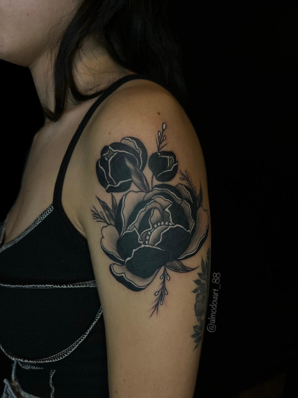 Black, grey and white upper arm stylized peony tattoo by Sacred Mandala Studio tattoo artist Lita Almodovar in Durham, NC.